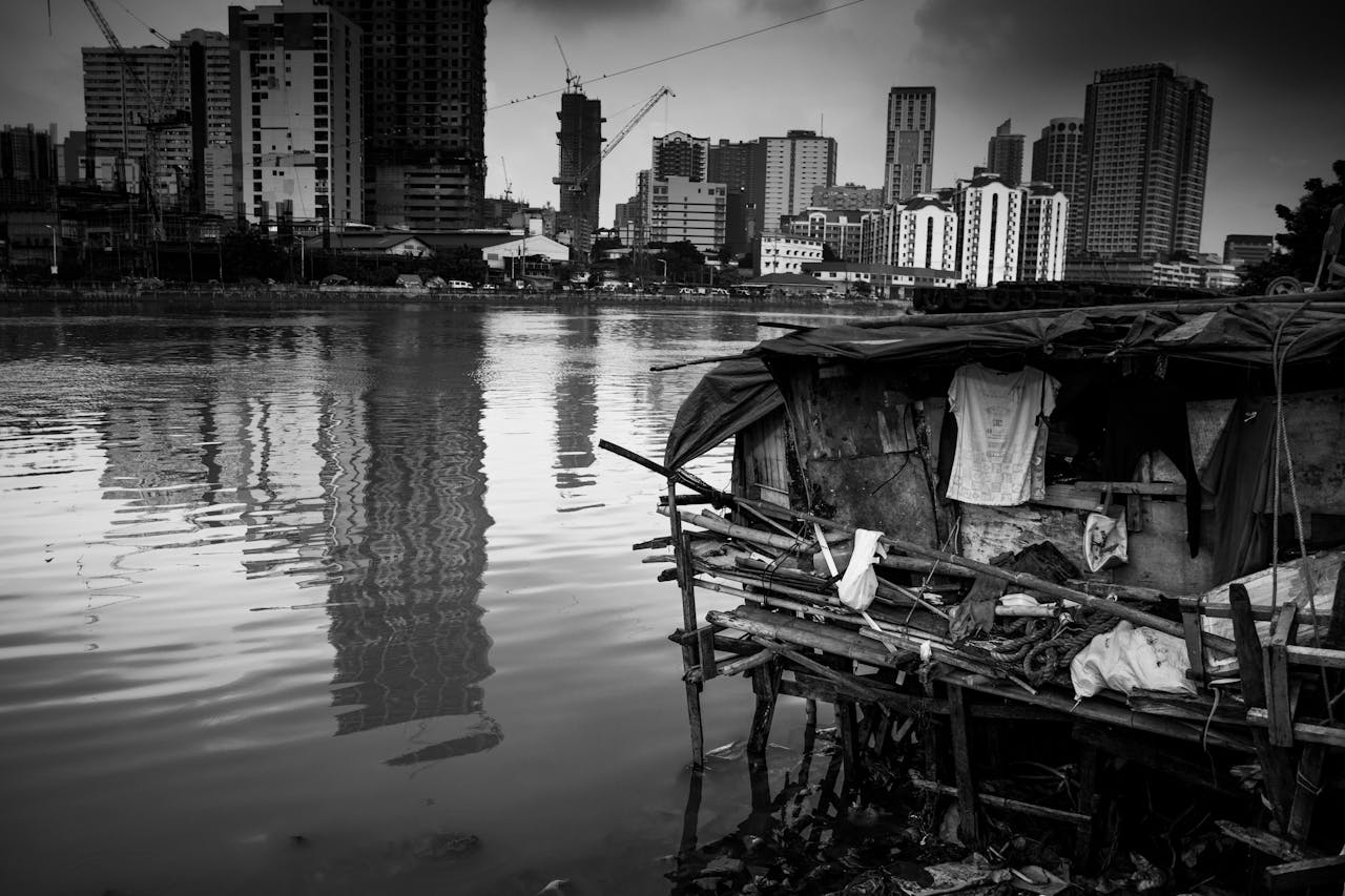 services-03 Grayscale cityscape with a waterfront and urban reflections.